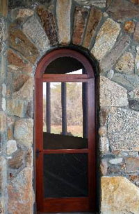 Carver Group's custom arched wooden and rock doorway